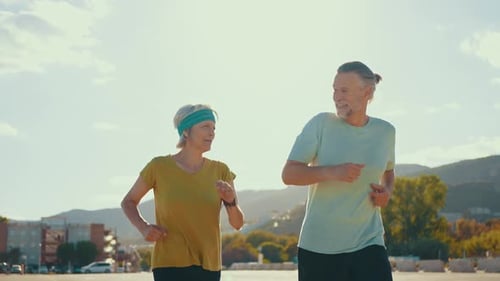 Mature Couple Jogging Together in Urban Setting