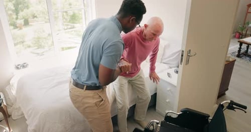 Young Adult Helps Senior Get Out of Bed