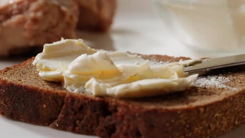 Butter Spread on Dark Bread Slice Close Up