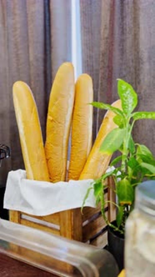 Fresh French Baguettes in Rustic Crate – 4K Vertical Bakery Display.