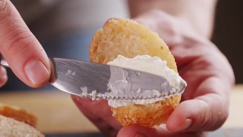 Close-Up Spreading Cream Cheese on Bread Slice