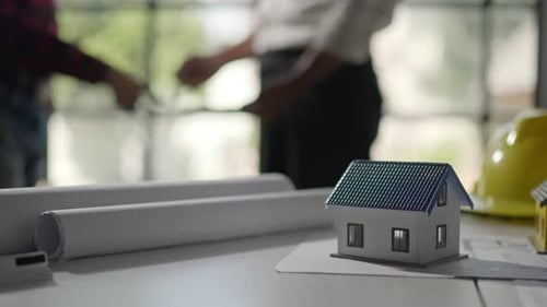 Hands working brainstorming and measuring for cost estimating on architectural and engineering.