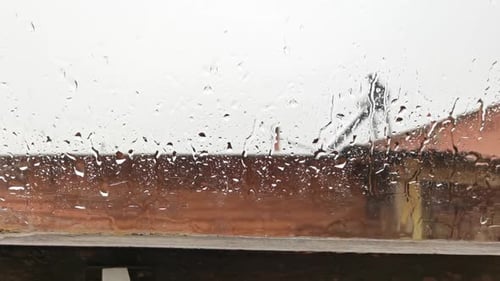 Raindrops Flowing on a Window on a Rainy Day