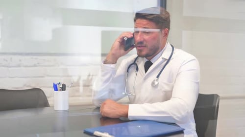 Phone Talk by Middle Aged Male Doctor in Hospital