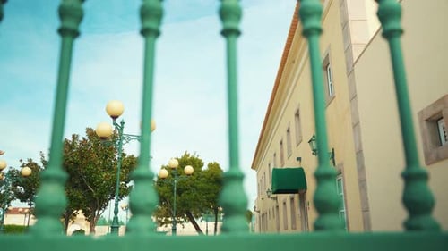 Mansion facade with public lamp through iron fences truck shot 4K