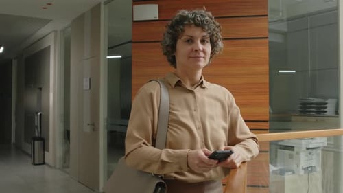 Portrait of Smiling Female Executive with Phone