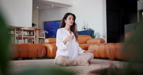 Woman Meditating with Incense in Peaceful Home