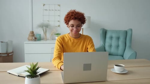 African American Girl Using Laptop at Home Office Looking at Screen Typing Chatting Reading Writing