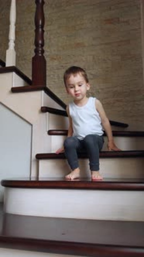 Barefoot Child Walking Down Home Staircase