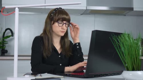 Exhausted Young Woman at Home Office Desk Working Late at Night Portrait of Tired and Stressed