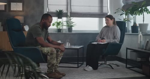 Man Talking With Therapist in Comfortable Office Setting