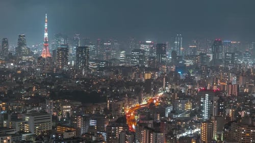 Beautiful night timelapse of Tokyo, Japan. Cityscape skyline with Tokyo Tower. Wide shot, zoom out.