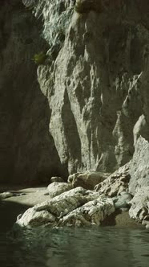 Rocky Cliffside By Calm Waters at Dusk