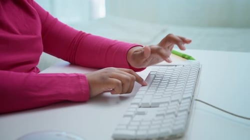 Office Worker Typing on White Keyboard