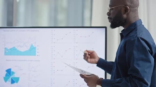 Entrepreneur Showing Chart on Big Screen at Business Conference
