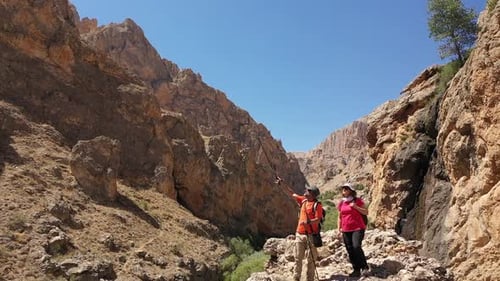 Aerial View Of Two Climbers Watching Around The Canyon 2