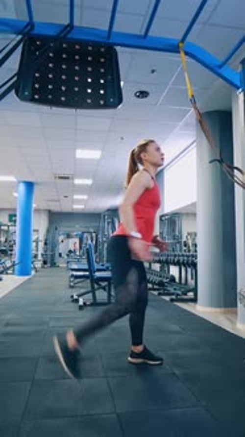 Beautiful woman working out in gym. Healthy young athletes woman doing exercises at gym