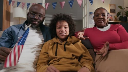 Family Celebrates with Flags and Joyful Smiles