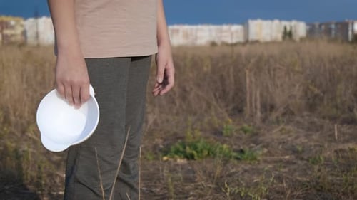 Indeterminate Aged Child Standing in Field Holding Bowl