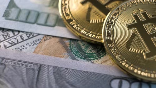 Close Up of Metal Shiny Bitcoin Crypto Currency Coins on US Dollar Bills