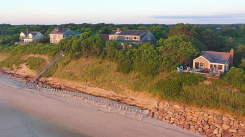Cape Cod Bay Aerial Drone Footage of Beach Front Houses at Low Tide with Lowering Motion During Gold
