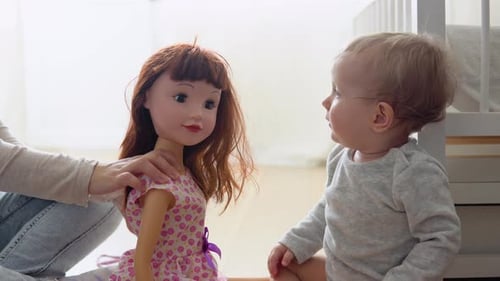 Kid Girl Playing with a Doll at Home or Kindergarten