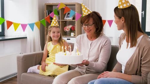 Family Celebrates Birthday Together at Home on Sofa