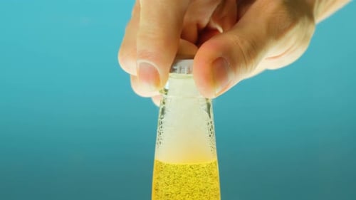 Beer Bottle Opening with Bubbles and Foam