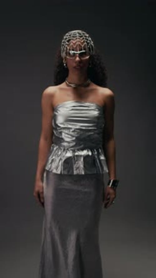 Woman in Silver Fashion Posing in Studio