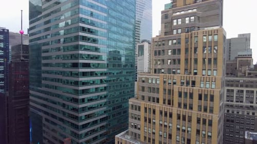 Aerial birds eye overhead top view of tall office of apartment buildings. Pan Shot
Cars moving on st