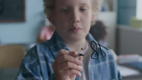 Boy Solving Division Problem at Glass Board During Math Lesson