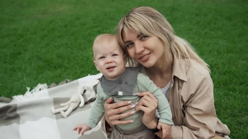Beautiful Young Mother And Her Child On Lawn