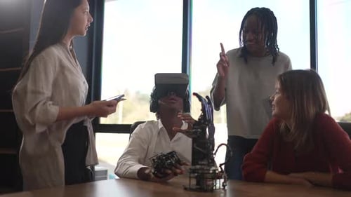 Group of students are brainstorming and working with robot arm at the science workshop.