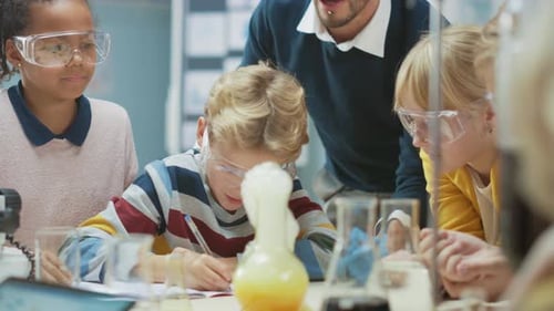 Elementary School Science Classroom: Enthusiastic Teacher Explains Chemistry to Diverse Group of Ch