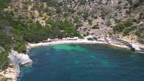 turquoise water Ibiza secret rocky cove bay. Amazing aerial view flight drone