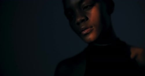 Young Woman Posing in Dramatic Lighting