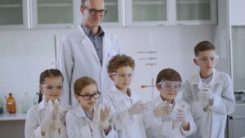 Enthusiastic Children Applauding in a Science Lab