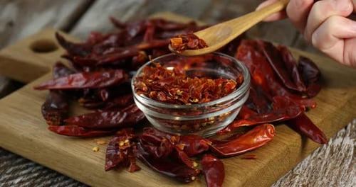 Dried Chili Peppers with Wooden Spoon and Clear Bowl