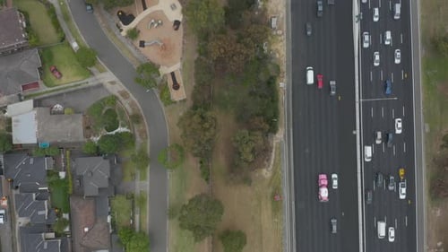 Aerial perspective following busy highway with traffic running in both directions.