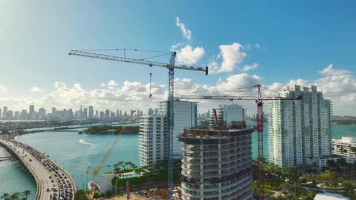 Tower Lifting Cranes at High Residential Apartment Building Construction Site Real Estate