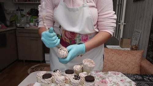 A Woman Makes Flowers Out Of Zephyr. Decorates Waffle Cones With Marshmallows. Close Up.
