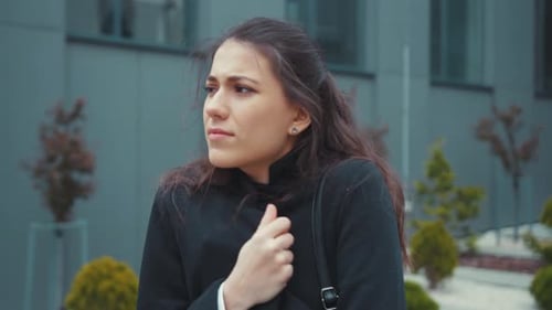 Woman Coughing and Clutching Her Chest Outdoors