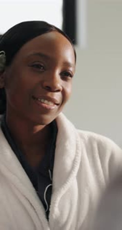 Woman Uses Jade Roller on Face in Bathroom