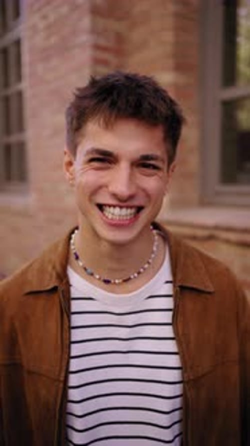 Happy Handsome Caucasian Man with Big Smile Posing Looking Laughing at Camera on University Campus