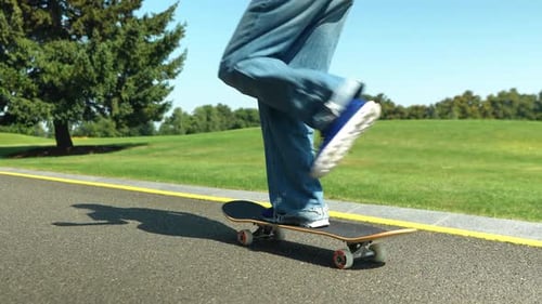 Closeup of Trendy Teen Girl Skateboarder Riding on Skateboard in Public Park