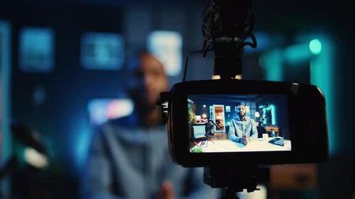 Man Recording Himself on Camera at Night