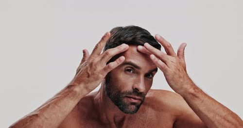 Beauty, face and inspection with man in studio for daily dermatology routine