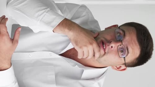 Stressed Man Sighs and Puts Hand to Face