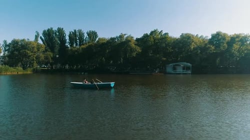 Couple in the boat int the center of the lake