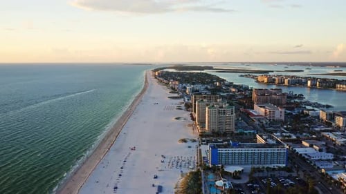 Clearwater Beach shoreline stretching along Gulf waters with resorts — aerial perspective